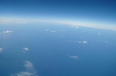 Clouds and blue sky seen from plane Stock Photos