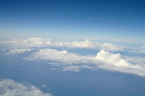 Clouds and blue sky seen from plane Stock Photos