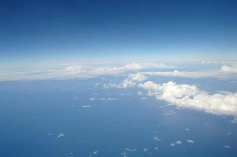 Clouds and blue sky seen from plane Stock Photos