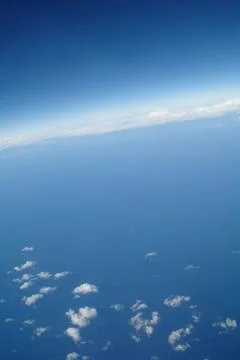Clouds and blue sky seen from plane Stock Photos