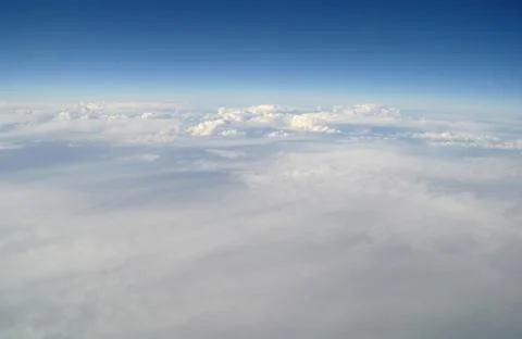 Clouds and blue sky seen from plane Stock Photos