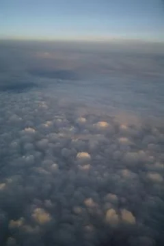 Clouds and blue sky seen from plane Stock Photos