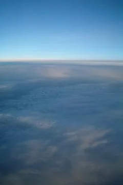 Clouds and blue sky seen from plane Stock Photos