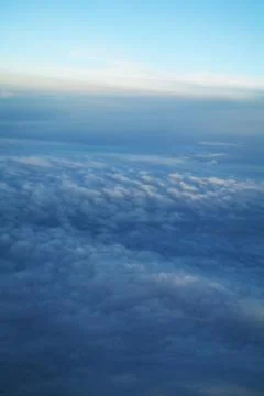 Clouds and blue sky seen from plane Stock Photos