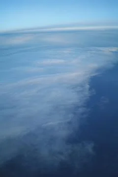 Clouds and blue sky seen from plane Stock Photos
