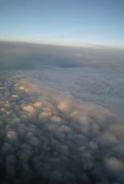 Clouds and blue sky seen from plane Stock Photos