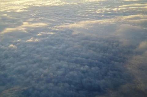 Clouds and blue sky seen from plane Stock Photos