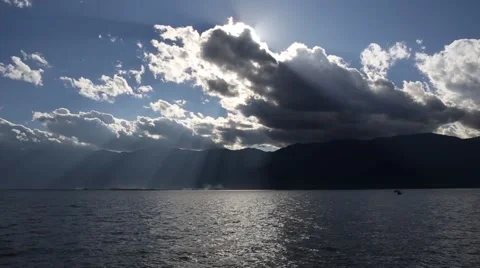 Clouds and boat over a mountain lake Stock Footage 49524168