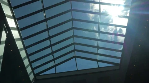 Clouds and a bright sun looking up through a large sun roof. Stock Footage 75832155