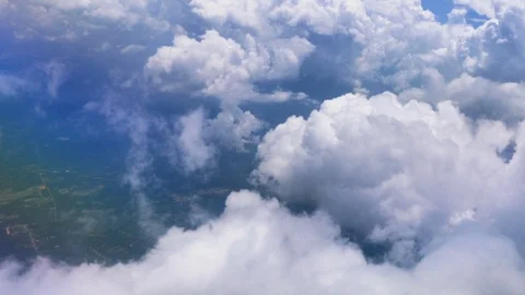 Clouds and earth passing by view from a board of flying airplane. Stock Footage 110352307