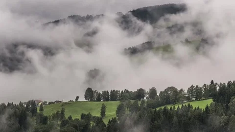 Clouds and fog moving through green hills Stock Footage 80123268