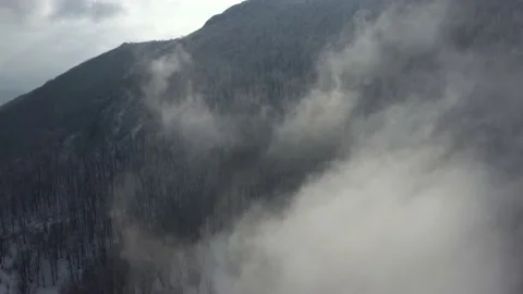 Clouds and fog passing over the mountain woods 4K drone footage Stock Footage 102575137