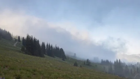 Clouds and fog passing on the side of a hill Stock-Footage 78907282