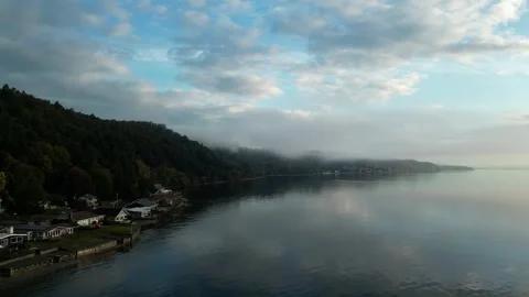 Clouds and fog rolling in on small island in pacific north west Stock Footage 294707330