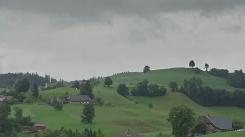 Clouds and fog rolling through hills in the Emmental in Switzerland Video stock 258418590