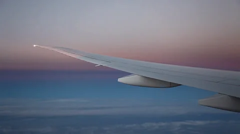 Clouds and fog seen through the window of jet airplane during sunset 库存影片 35054159