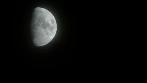 Clouds and haze distort big bright first quarter half moon northern hemisphere Stock Footage 81607220