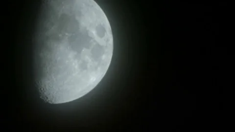 Clouds and haze distort big bright first quarter half moon northern hemisphere Stock-Footage 81608532