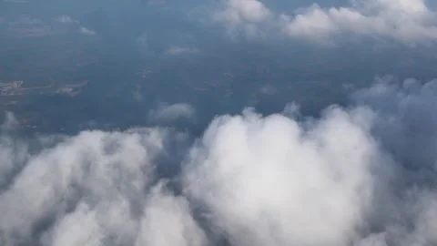 Clouds and land passing by during airplane flight 스톡 동영상 310191571