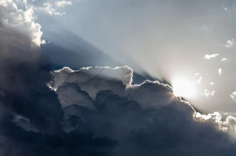 Clouds and Light. Sunlight backlights clouds with blue sky. Stock Photos