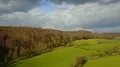 Clouds and meadows aerial shot sunny low mountain range valley spring season 4k 4k or 4k+ Resolution