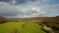 Clouds and meadows aerial shot sunny low mountain range valley spring season 4k 4k or 4k+ Resolution