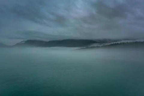 Clouds and mist over the forest and water in Prince Williams Stock Photos