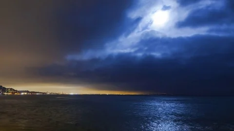Clouds and Moonlight Over the Beach at Night Video stock 76636395