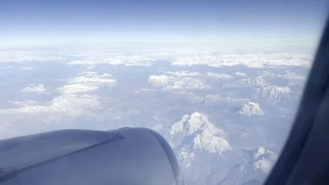 Clouds and mountains from airplane window (Slow Motion) Stock Footage 344232134