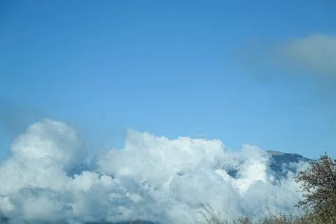 Clouds and mountains Stock Photos