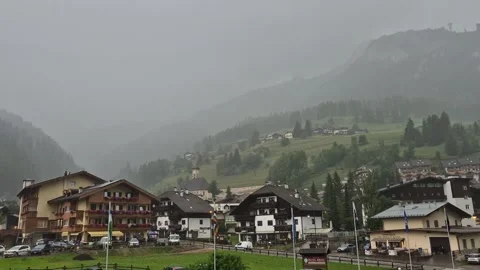 Clouds and rain above Campitello di Fassa and Sassolungo - Val di Fassa - Italy Stock Footage 281099532