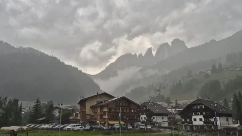 Clouds and rain above Campitello di Fassa and Sassolungo - Val di Fassa - Italy Video stock 281099650