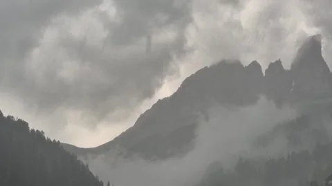 Clouds and rain above Campitello di Fassa and Sassolungo - Val di Fassa - Italy Video stock 281099720