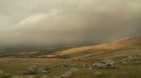 Clouds and Rain pass over rolling hills and mountains Video stock 506762