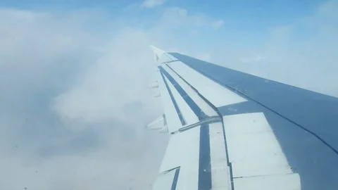 Clouds and sky and mountains as seen through window of an aircraft Video stock 81500274