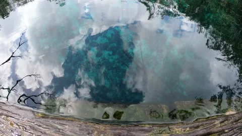 Clouds and sky reflected in the water at a Yucatan cenote Stock Footage 196818656