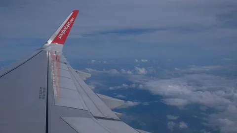 Clouds and sky as seen through a window of an aircraft flying Stock Footage 99105126