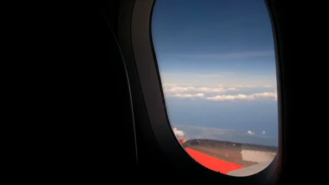 Clouds and sky as seen through window of an aircraft flying Stock Footage 103196156