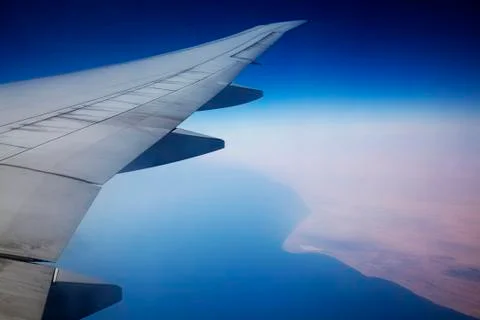Clouds and sky as seen through window of an aircraft Stock Photos