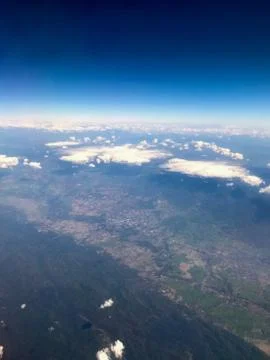 Clouds and sky as seen through window of an aircraft Stock Photos