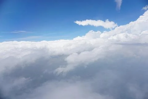 Clouds and sky as seen through window of an aircraft Stock Photos
