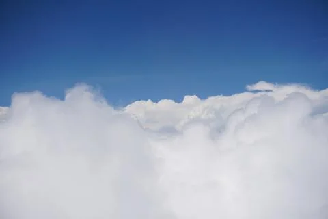 Clouds and sky as seen through window of an aircraft Stock Photos