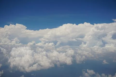 Clouds and sky as seen through window of an aircraft Stock Photos