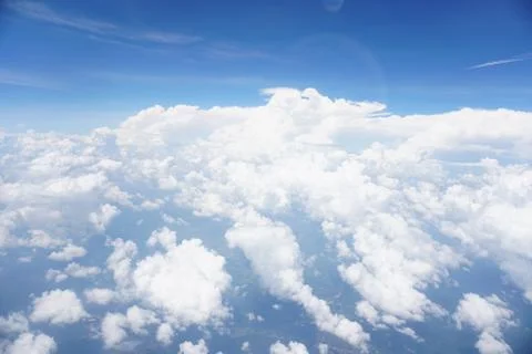 Clouds and sky as seen through window of an aircraft Stock Photos