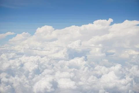 Clouds and sky as seen through window of an aircraft Stock Photos