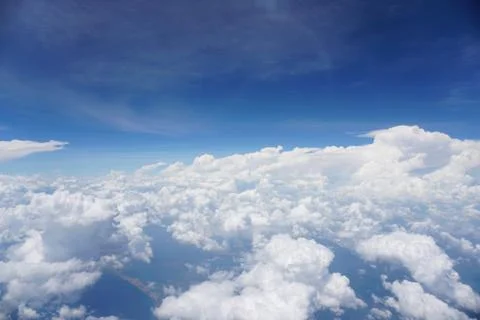 Clouds and sky as seen through window of an aircraft Stock Photos