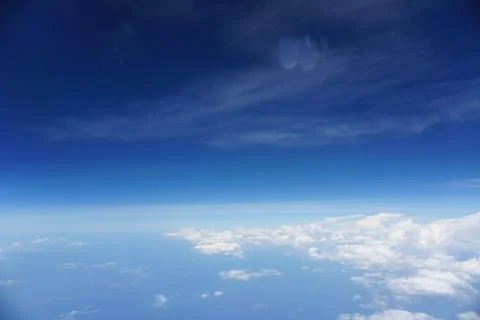 Clouds and sky as seen through window of an aircraft Stock Photos