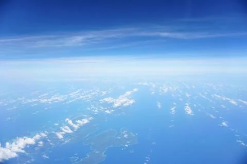 Clouds and sky as seen through window of an aircraft Stock Photos