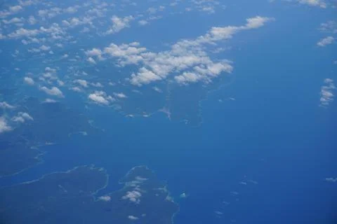 Clouds and sky as seen through window of an aircraft Stock Photos