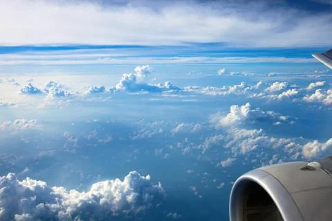 Clouds and sky as seen through window of an aircraft Stock Photos